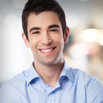 man smiling with arms crossed